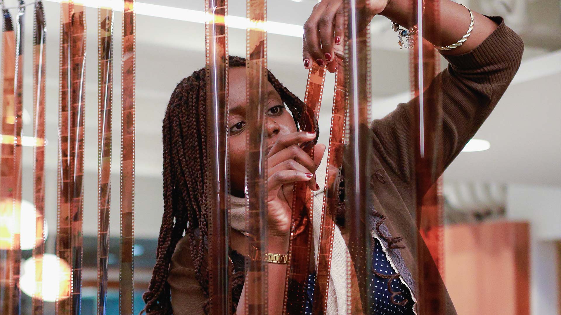 A volunteer looking through camera film strips